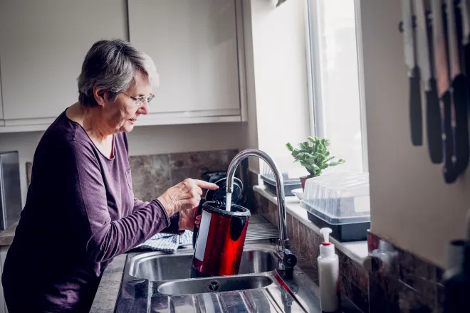 Woman filling kettle