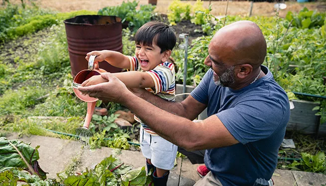 Youngster playing with an adult on the garden