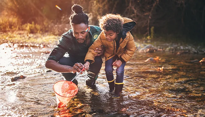 Man and boy in stream